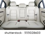 Back passenger seats in modern luxury car, frontal view, white leather