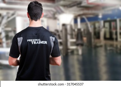 Back Of A Personal Trainer In A Gym