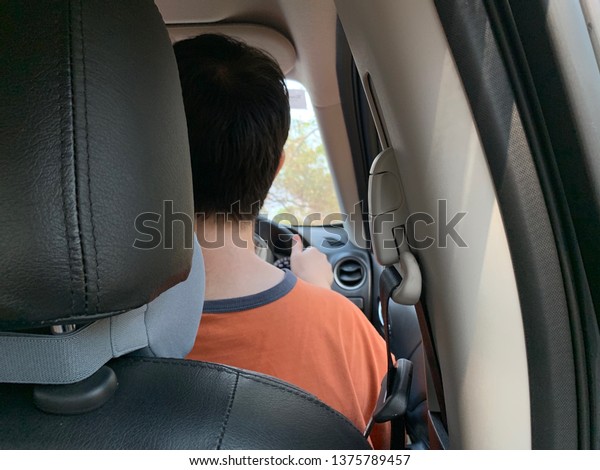 The back photos\
of men driving inside the\
car