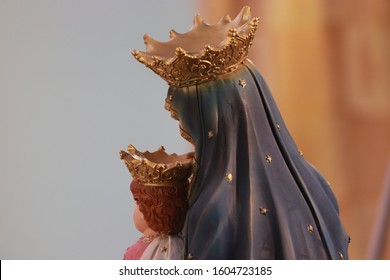 Back Pic Of Mother Mary Holding Baby Jesus In Her Hands They Are Hiding Face Because World Is Full Of Sin You Can See Crown On Heads Of Mother Mary Jesus Gray And Golden And White Color 