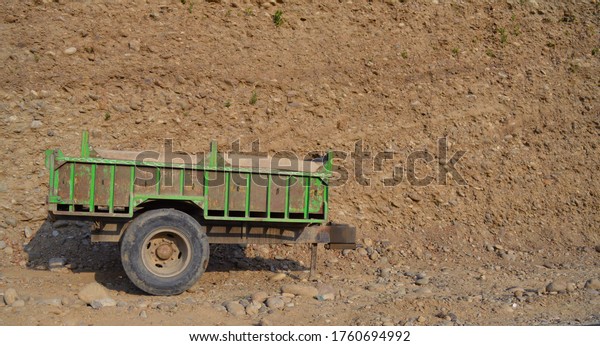 Back piece of a lorry stranded in a\
mud way.The frame of the back piece is colored in\
Green.
