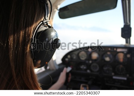 Back Of Pilot Flying Plane