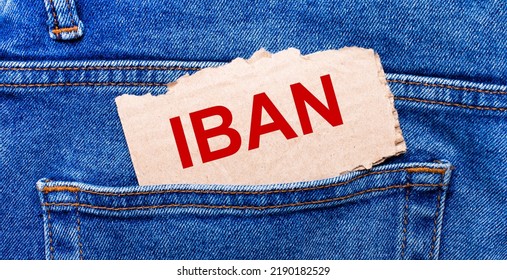 In The Back Pocket Of The Jeans There Is A Brown Piece Of Paper With The Text IBAN International Bank Account Number