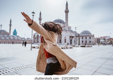 Back Portrait Of Happy Kid Dancing In The Square Of Konya With Mosque At The Background