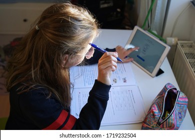 Back Of A Real 10 Year Old Girl Doing Homeschooling, Learning At Home, Doing Homework                              