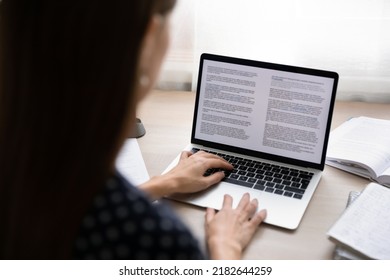 Back rear close up view focused young businesswoman working on electronic documents in computer editing application. Concentrated professional journalist writing article or student writing essay. - Shutterstock ID 2182644259