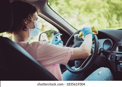 Back rear spine view photo of girl car driver ride sit inside cabin disinfect steering, wheel from covid infection clean rag wear medical mask blue latex gloves in city center journey