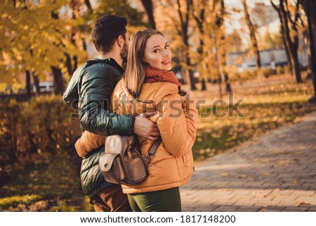 Back rear spine view photo of harmony romantic couple walk in october autumn forest town park hugging wear coats