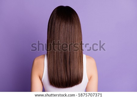 Back rear spine view photo of brown haired young woman pretty lovely natural hair isolated on purple color background