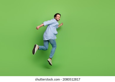 Back rear view full body photo of young handsome guy go jumper fast isolated over green color background - Powered by Shutterstock