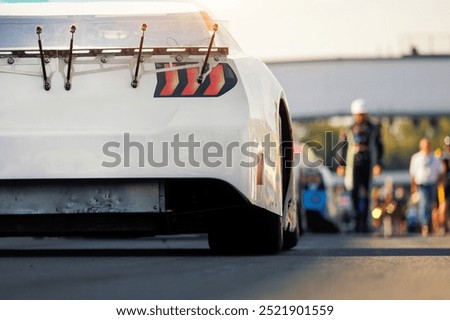 Back rear view Nascar Whelen euro series white racing sportscar car auto pit lane ready for race. Motorsports Team competition. Racetrack start grid vehicle. European motor auto sport challenge