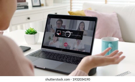 Back rear view young asian woman employee work from home using computer notebook videocall meeting conference angry annoy with low poor unreliable internet wifi connection problem issue outage. - Shutterstock ID 1932034190