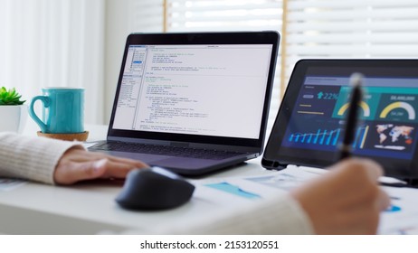 Back Rear View Of Young Asian Woman, Freelance Data Scientist Work Remotely At Home Coding Programing On Big Data Mining, AI Data Engineering, IT Technician Works On Artificial Intelligence Project.