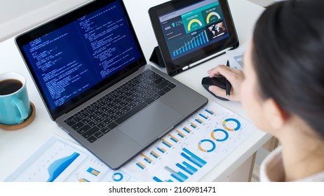 Back Rear View Of Young Asian Woman, Freelance Data Scientist Work Remotely At Home Coding Programmer On Big Data Mining, AI Data Engineering, IT Technician Works On Artificial Intelligence Project.