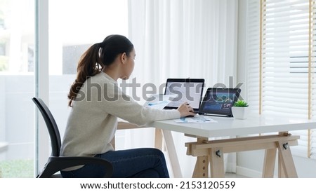 Back rear view of young asian woman, freelance data scientist work remotely at home coding programing on Big data mining, AI data engineering, IT Technician Works on Artificial Intelligence Project.