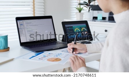 Back rear view of young asian woman, freelance data scientist work remotely at home coding programming on Big data mining, AI data engineering, IT Technician Works on Artificial Intelligence Project.