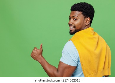 Back Rear View Young Smiling Happy Man Of African American Ethnicity 20s Wear Blue T-shirt Showing Thumb Up Like Gesture Isolated On Plain Green Background Studio Portrait. People Lifestyle Concept