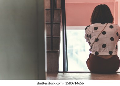 Back Sad Asia Woman Sitting Stairwell Fire Escape.Depression And Problem Concept.