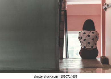 Back Sad Asia Woman Sitting Stairwell Fire Escape.Depression And Problem Concept.