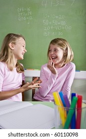 Back To School - 8 Year Old Girls In Classroom Talking And Smiling