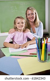 Back To School - 8 Year Old Student And Teacher Writing In Classroom