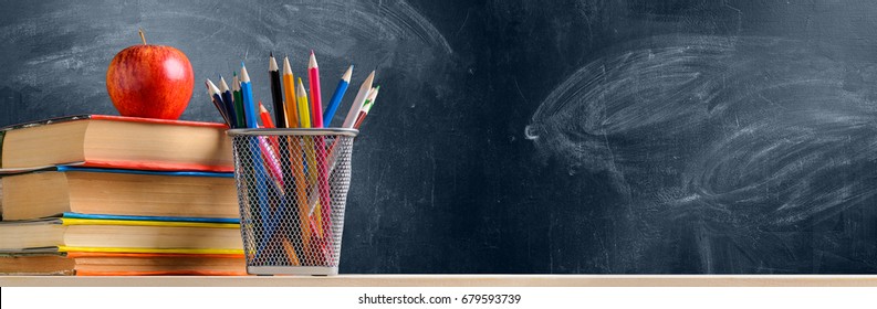 Back To School. Accessories, Books And Fresh Apple Against Chalkboard