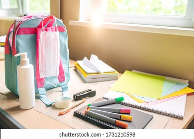 Back to school after quarantine concept. Backpack with school supplies and sanitizer and medical protective mask. the beginning of the school season.  - Powered by Shutterstock