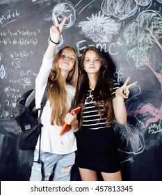 Back To School After Summer Vacations, Two Teen Real Girls In Classroom With Blackboard Painted Together