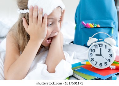 Back To School. Alarm,clock. Little Screaming Girl Sleeps In Bed.Schoolgirl Overslept,woke Up Late To Study.Backpack,multi Colored Markers,pencils, Notebooks.Soft Cat Mask.Bedtime.Child Daily Routine.