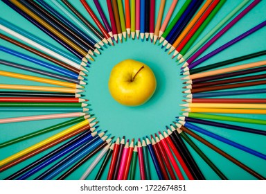 Back To School. Apple And Colored Pencils Are Laid Out In A Circle