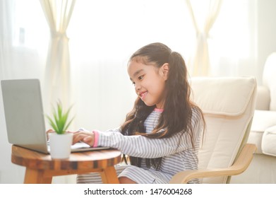 Back To School. Asian Little Girl Using His Laptop