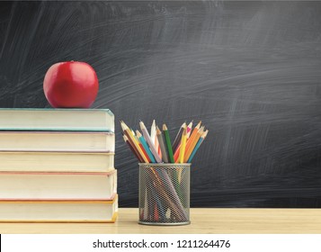 Back To School Background With Books And Apple Over Blackboard