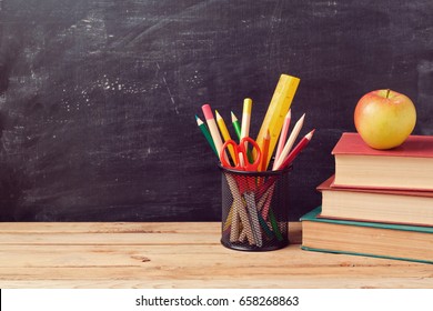 Back To School Background With Books, Pencils And Apple Over Chalkboard