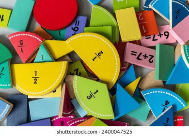 back to school background. colorful math fractions and notebook on the table. Mathematics and geometry in preschool and school