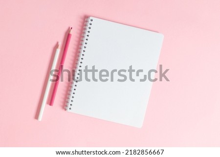 Back to school background. Flat lay, top view of colorful scattered stationery on isolated pastel light pink table background. School supplies on desk. Copyspace.