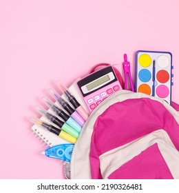 Back to school backpak with school stationery on pastel pinkbackground. Flat lay
