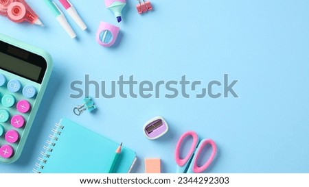 Back to school banner design. Stylish school supplies with calculator on pastel blue background.