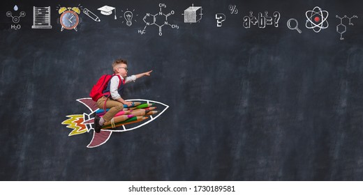 Back to school. Boy flying on rocket from colorful pencils and pointing up. 