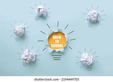 Back to school bright bulb amongst crumpled pieces paper  inspiration success concept