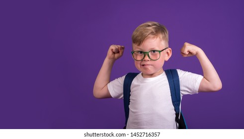 Back To School. Child Playing Superhero With Huge Muscle Arms. Nerd Kid In Glasses. Boy Isolated On Colored Blackboard. Success, Bright Idea, Creative Ideas And Innovation Technology.