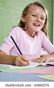 Back To School - Close-up Of 8 Year Old Girl Writing In Notebook