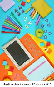 Back To School Colorful Kid's Theme Concept Flat Lay With Blackboard, Notebook, Stationery And Apple For The Teacher.