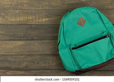 Back to school concept - blue backpack on wooden backgroung, Flat lay