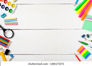 Back To School Concept, Border Frame Of Colorful Stationery Supplies For Teaching Kids Drawing On Empty White Wooden Desk. Creative Education Setting, Kids Desk Top View. 