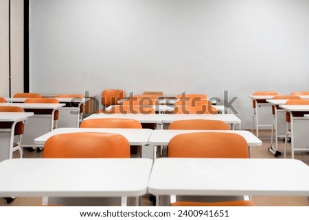 back to school concept, empty classroom with white tables and chairs
