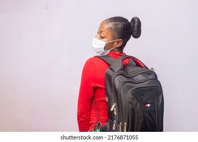 Back To School Concept, Female Student Carrying Backpack Looking Back, Young Black College Student On Medical Nose Mask.