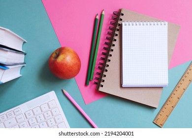 Back to school concept flat lay photo. Books, computer keyboard, notepad, pencils, wooden ruler, apple on a table - Powered by Shutterstock