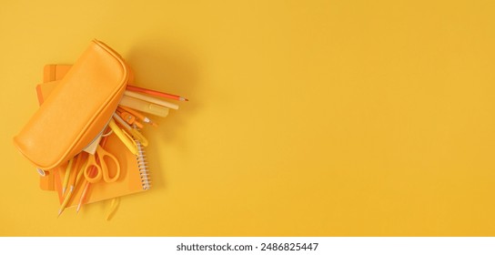 Back to school concept. Flat lay top view on full pencil case with pencils and pens with notebook isolated on yellow background with empty space for text