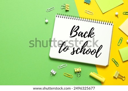 Back to school concept. Flat lay with colorful school stationery and notebook on color background, top view