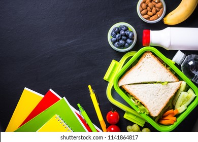 Back To School Concept. Lunch Box With Stationery On Black.